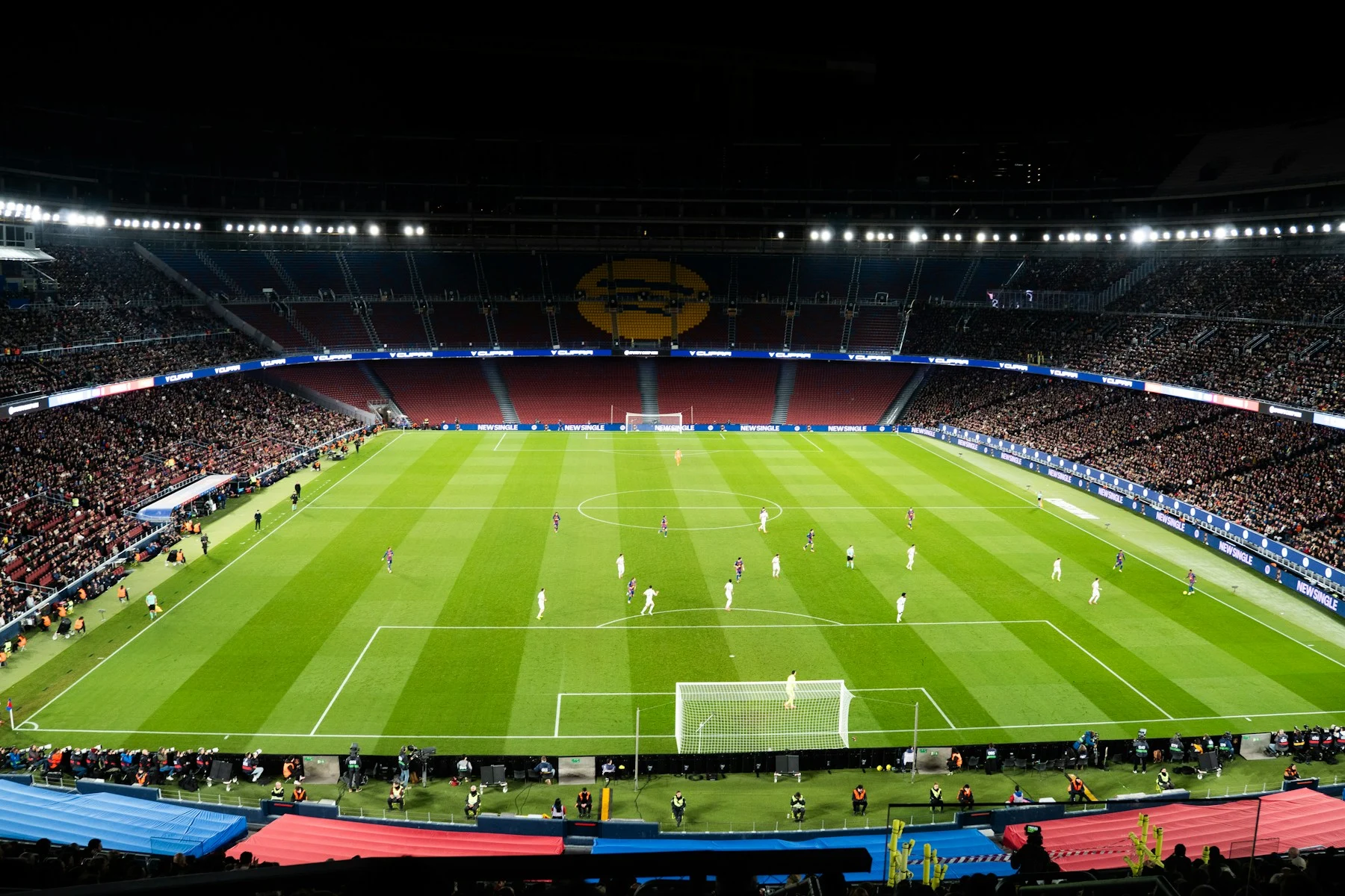 Live football match in a floodlit stadium